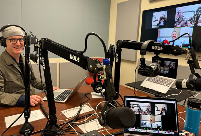 DJ Hopkins sits in the multitrack recording studio working on the Faculty Futures Podcast. His guest appears on Zoom.